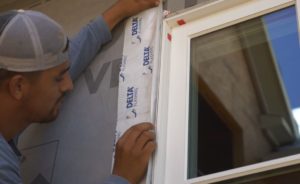 Applying DELTA®-FLASHING over the window flanges