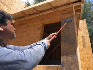 applying the primer to the sheathing
