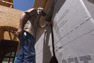man cutting out the window area