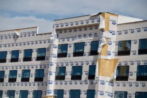 house wrap peeling off a large building