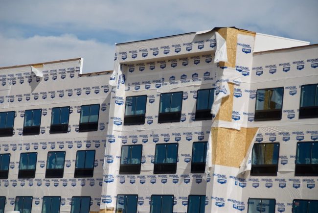 house wrap peeling off a large building