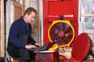 Man on a laptop conducting a blower door test